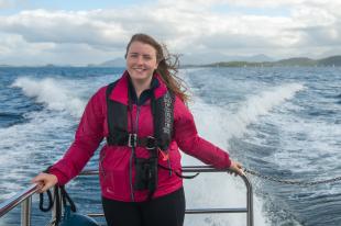 Leigh standing at the back of boat at sea