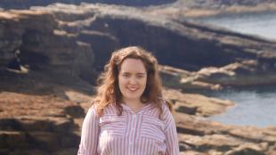 Tara Alkubaisi profile photo with Orkney coastline in the background