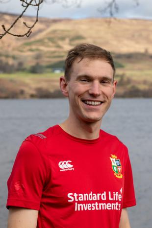photo of Tom Summers with sea and mountains in the background